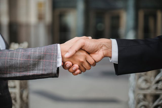 two people in suits shaking hands